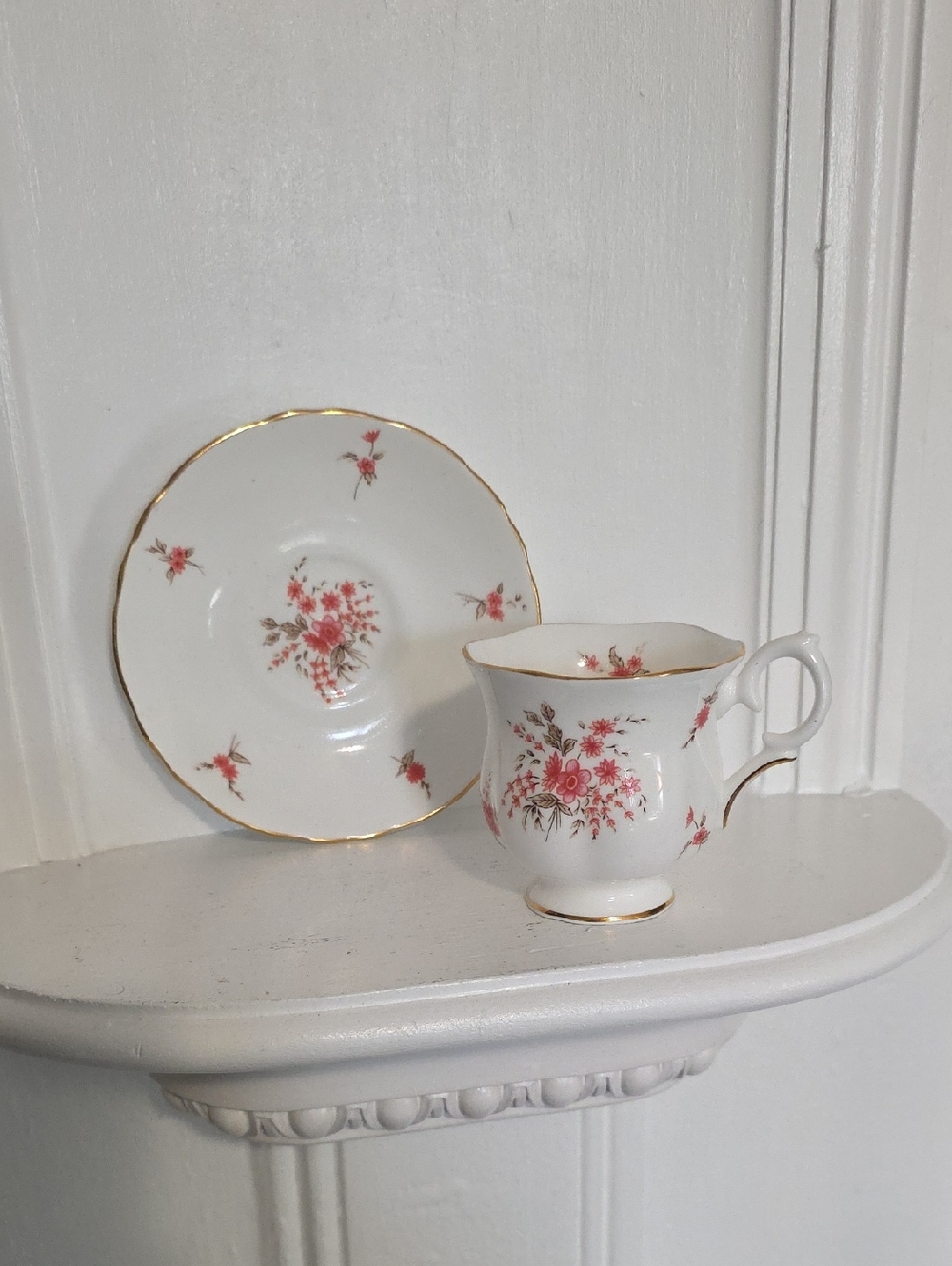 vintage Crown Staffordshire fine bone china teacup and saucer featuring a floral